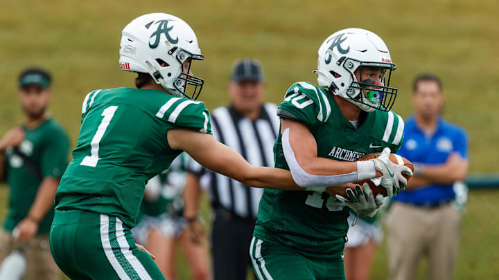 Archmere quarterback John Orsini (left) hands off to junior Ryan Hagenberg during Caravel’s 42-6 win over the Auks at Coaches’ Field on Saturday, Sept. 28, 2024. Archmere quarterback John Orsini (left) hands off to junior Ryan Hagenberg during Caravel’s 42-6 win over the Auks at Coaches’ Field on Saturday, Sept. 28, 2024.
