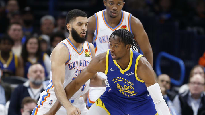 Feb 7, 2022; Oklahoma City, Oklahoma, USA; Golden State Warriors forward Jonathan Kuminga (00) drives to the basket against Oklahoma City Thunder forward Kenrich Williams (34) during the second half at Paycom Center. Golden State won 110-98. Mandatory Credit: Alonzo Adams-USA TODAY Sports