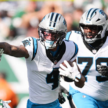 Oct 19, 2025; East Rutherford, New Jersey, USA; Carolina Panthers wide receiver Tetairoa McMillan (4) stiff arms New York Jets cornerback Sauce Gardner (1) in the second quarter at MetLife Stadium. Mandatory Credit: Vincent Carchietta-Imagn Images