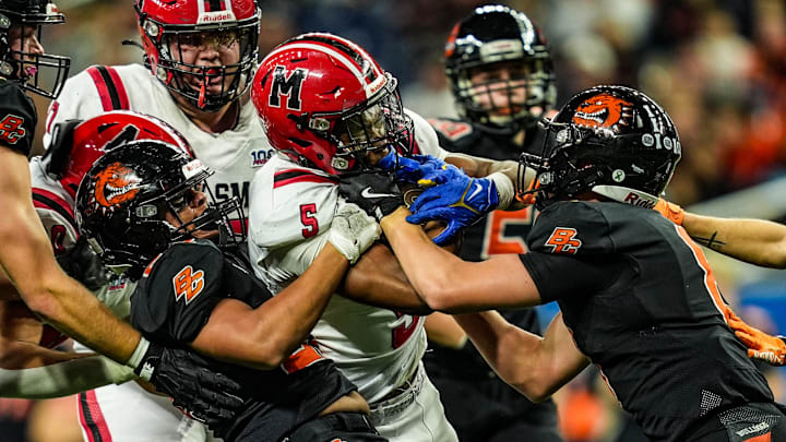 Orchard Lake St. Mary’s RB Derrin Jones (5) is tackled by Byron Center in the Michigan High School Athletic Association division two football finals at Ford Field in Detroit on Friday, Nov. 29, 2024. Orchard Lake St. Mary’s RB Derrin Jones (5) is tackled by Byron Center in the Michigan High School Athletic Association division two football finals at Ford Field in Detroit on Friday, Nov. 29, 2024.