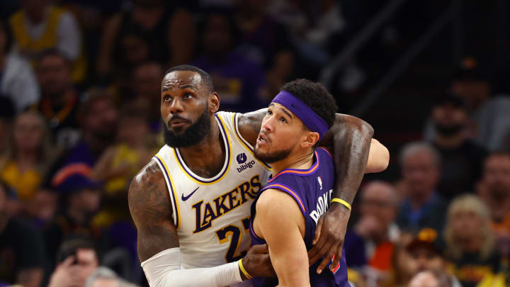 Feb 25, 2024; Phoenix, Arizona, USA; Los Angeles Lakers forward LeBron James (23) against Phoenix Suns guard Devin Booker (1) at Footprint Center. Mandatory Credit: Mark J. Rebilas-USA TODAY Sports