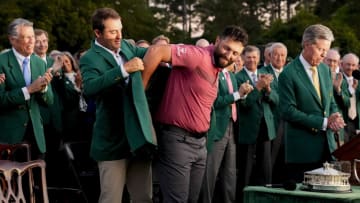 Apr 9, 2023; Augusta, Georgia, USA; 2022 Masters champion Scottie Scheffler helps Jon Rahm into his