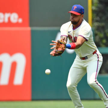 Jul 28, 2024; Philadelphia, Pennsylvania, USA; Philadelphia Phillies shortstop Edmundo Sosa loses sight of the ball.