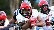 Sep 20, 2025; Durham, North Carolina, USA;  North Carolina State Wolfpack running back Jayden Scott (4) runs the ball during the first quarter against the Duke Blue Devils at Wallace Wade Stadium. Mandatory Credit: Zachary Taft-Imagn Images