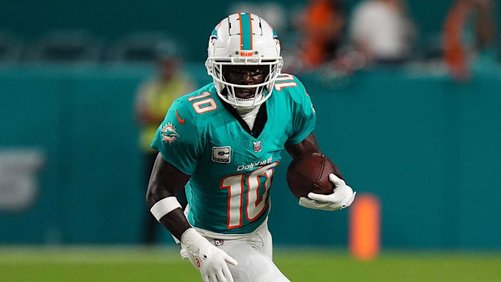 Miami Dolphins receiver Tyreek Hill runs with the ball. Miami Dolphins receiver Tyreek Hill runs with the ball.