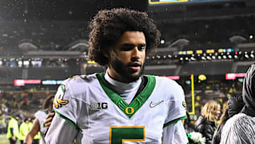 Oregon Ducks quarterback Dante Moore runs off the field after the game against the Iowa Hawkeyes at Kinnick Stadium.