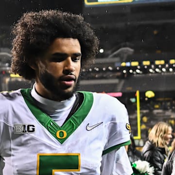 Oregon Ducks quarterback Dante Moore runs off the field after the game against the Iowa Hawkeyes at Kinnick Stadium.