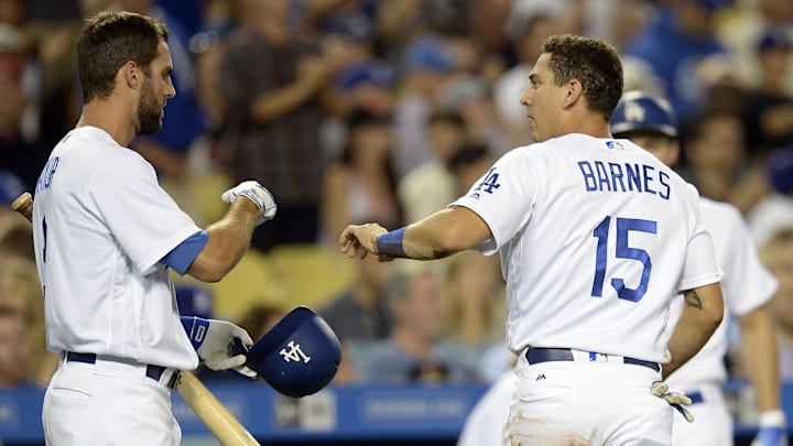 Dodgers catcher Austin Barnes (15) is greeted by Los Angeles Dodgers left fielder Chris Taylor (3) after scoring a run in the fifth inning against the San Francisco Giants at Dodger Stadium. 