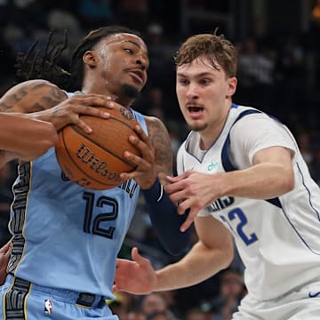 Nov 7, 2025; Memphis, Tennessee, USA; Memphis Grizzlies guard Ja Morant (12) drives to the basket against Dallas Mavericks guard Max Christie (00) and forward Cooper Flagg (32) during the second quarter at FedExForum. Mandatory Credit: Petre Thomas-Imagn Images