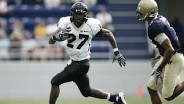 Oct 20, 2007; Annapolis, MD, USA; Wake Forest Demon Deacons running back Josh Adams (27) carries the ball as Navy Midshipmen safety Blake Carter (1) defends in the first quarter at Navy-Marine Corps Memorial Stadium in Annapolis, MD.  Wake Forest won the game 44-24.  Mandatory Credit: James Lang-Imagn Images
