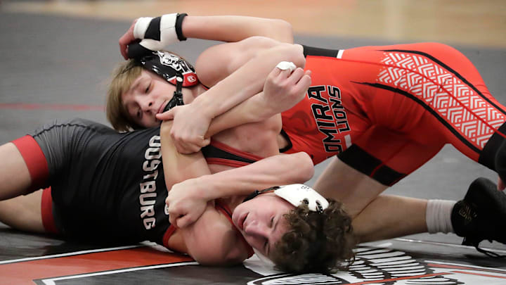 Oostburg’s Landon Holschbach, bottom, is gripped by Lomira’s Jordan Lisiecki in a match at 113-pounds during the WIAA Division 3 team sectional on February 18, 2025.