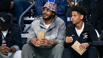 Carmelo Anthony and his son, Kiyan, watch the Don Bosco Prep Ironmen compete against the McEachern Indians
