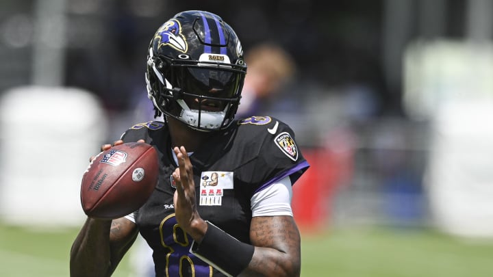 Jul 27, 2024; Owings Mill , MD, USA; Ravens quarterback Lamar Jackson (8) looks up field to throw during the afternoon session of training camp at the Under Armour Performance Center,  Mandatory Credit: Tommy Gilligan-USA TODAY Sports