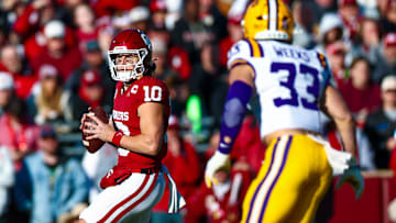Nov 29, 2025; Norman, Oklahoma, USA;  Oklahoma Sooners quarterback John Mateer (10) throws as Louisiana State Tigers linebacker West Weeks (33) defends during the first half at Gaylord Family-Oklahoma Memorial Stadium. Mandatory Credit: Kevin Jairaj-Imagn Images
