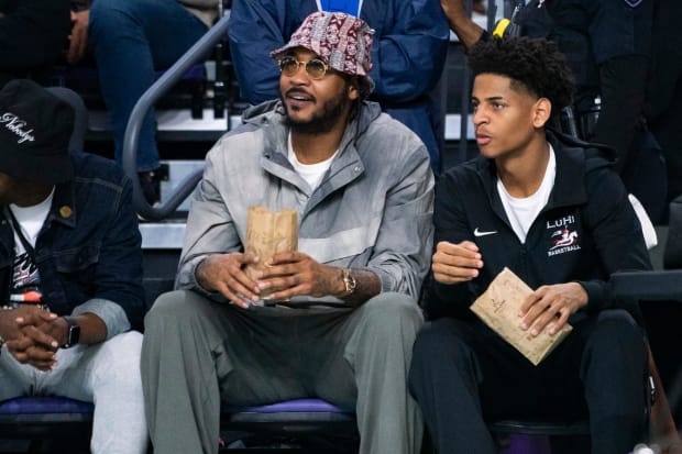 Carmelo Anthony and his son, Kiyan, watch the Don Bosco Prep Ironmen compete against the McEachern Indians in a game during the 50th annual City of Palms Classic at Suncoast Credit Union Arena in Fort Myers on Tuesday, Dec. 19, 2023. Kiyan Anthony and the Long Island Luthern Crusaders defeated Westminster Academy earlier in the day.