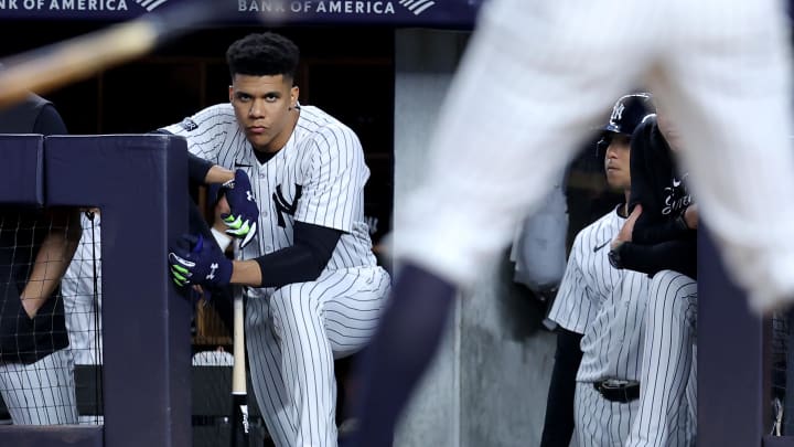 Jun 7, 2024; Bronx, New York, USA; New York Yankees right fielder Juan Soto (22) watches from the top step of the dugout as third baseman DJ LeMahieu (26) bats during the ninth inning against the Los Angeles Dodgers at Yankee Stadium. Mandatory Credit: Brad Penner-USA TODAY Sports