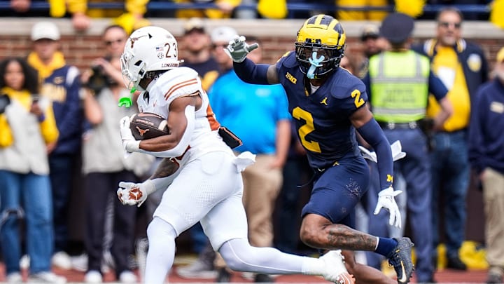 Michigan defensive back Will Johnson defends Texas running back Jaydon Blue during the first half at Michigan Stadium in Ann Arbor on Saturday, Sept. 7, 2024.