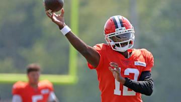 Cleveland Browns quarterback Shedeur Sanders (12) throws as quarterback Dillon Gabriel (5) looks on during NFL training camp at CrossCountry Mortgage Campus, Friday, Aug. 1, 2025, in Berea, Ohio.