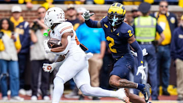 Michigan defensive back Will Johnson defends Texas running back Jaydon Blue during the first half at Michigan Stadium in Ann Arbor on Saturday, Sept. 7, 2024.