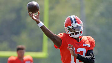 Cleveland Browns quarterback Shedeur Sanders (12) throws as quarterback Dillon Gabriel (5) looks on during NFL training camp at CrossCountry Mortgage Campus, Friday, Aug. 1, 2025, in Berea, Ohio.