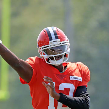 Cleveland Browns quarterback Shedeur Sanders (12) throws as quarterback Dillon Gabriel (5) looks on during NFL training camp at CrossCountry Mortgage Campus, Friday, Aug. 1, 2025, in Berea, Ohio.