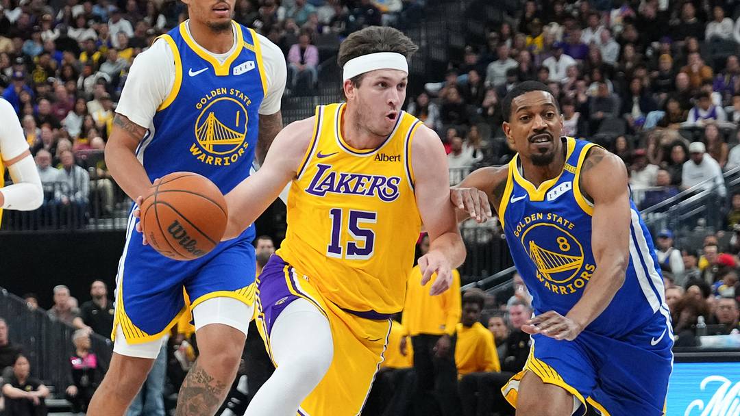 Oct 13, 2026; Las Vegas, Nevada, USA;  Los Angeles Lakers guard Austin Reaves (15) drives against Golden State Warriors guard De'anthony Melton (8) in the first quarter at T-Mobile Arena.  Mandatory Credit: Candice Ward-Imagn Images