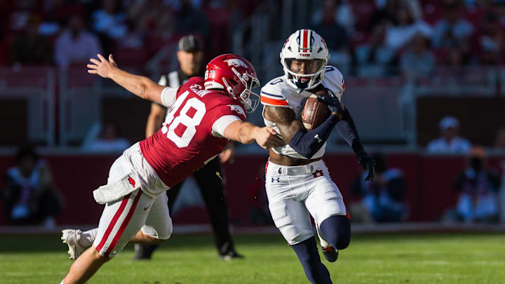 Nov 11, 2023; Fayetteville, Arkansas, USA;  Auburn Tigers cornerback Keionte Scott (0) returns a punt and gets past Arkansas Razorbacks long snapper Eli Stein (48) during the first quarter at Donald W. Reynolds Razorback Stadium. Auburn won 48-10. Mandatory Credit: Brett Rojo-USA TODAY Sports