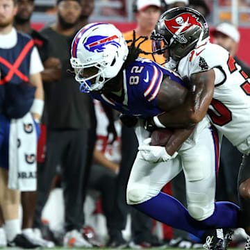 Aug 23, 2025; Tampa, Florida, USA; Tampa Bay Buccaneers wide receiver Jacob Harris (30) tackles Buffalo Bills wide receiver Kristian Wilkerson (82)