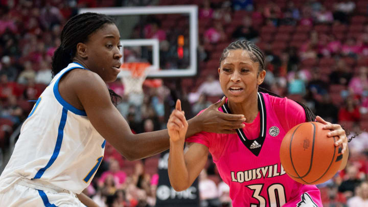 Louisville Cardinals guard Jayda Curry (30) dribbles down the court against Pittsburgh Panthers forward Rapuluchi Ayodele (15) during their game on Sunday, Jan. 28, 2024 at KFC YUM Center.