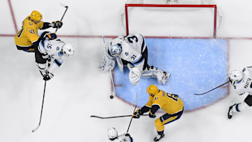 Apr 14, 2025; Nashville, Tennessee, USA;  Utah Hockey Club goaltender Matt Villalta (31) blocks a shot by Nashville Predators center Jonathan Marchessault (81) during the second period at Bridgestone Arena. Mandatory Credit: Steve Roberts-Imagn Images