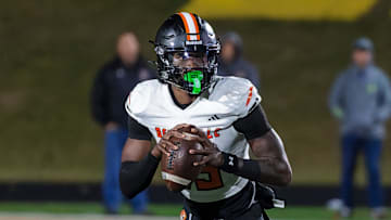 Belleville's Bryce Underwood rolls out to pass during a loss to Howell Friday, Oct. 25, 2024.
