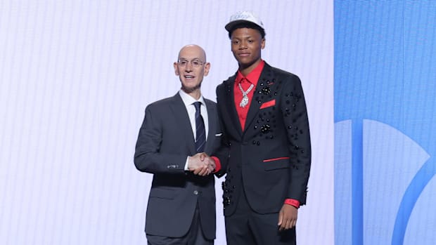 Adam Silver and Ace Bailey shake hands after Bailey was drafted by the Jazz.