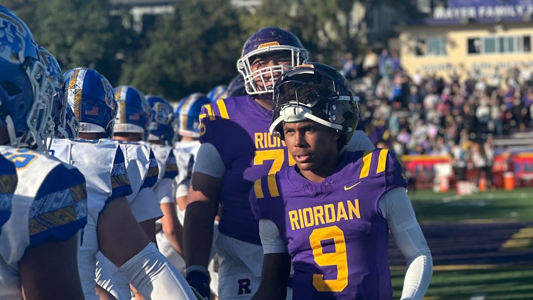 Riordan junior quarterback Mike Mitchell leads the handshake line after a stirring 27-21 home win over Serra on Nov. 2