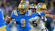Nov 22, 2025; Pasadena, California, USA;  UCLA Bruins quarterback Nico Iamaleava (9) the grasp of Washington Huskies linebacker Zach Durfee (5) during the second half at the Rose Bowl. Mandatory Credit: Jayne Kamin-Oncea-Imagn Images