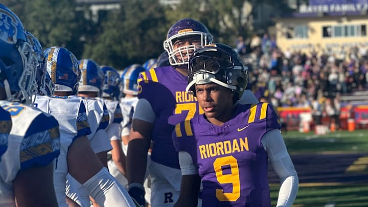 Riordan junior quarterback Mike Mitchell leads the handshake line after a stirring 27-21 home win over Serra on Nov. 2