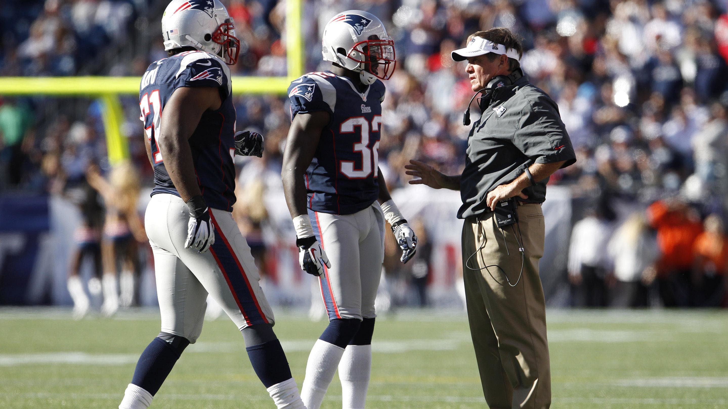 New England Patriots head coach Bill Belichick talks with Devin McCourty.