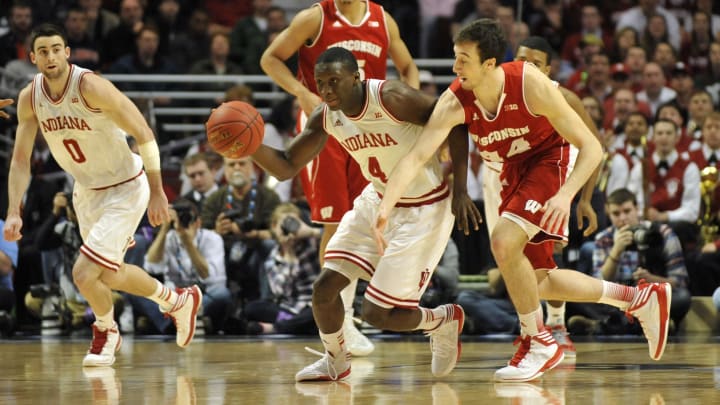 Indiana Hoosiers guard Victor Oladipo (4) brings the ball up court against Wisconsin Badgers forward Frank Kaminsky (44) in the first half during the semifinals of the Big Ten tournament at the United Center. Mandatory Credit: David Banks-USA TODAY Sports