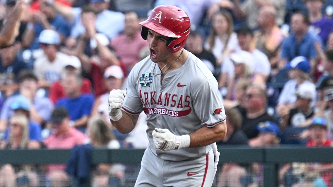 Jun 18, 2025; Omaha, Neb, USA;  Arkansas Razorbacks catcher Ryder Helfrick (27) circles the bases after hitting a home run against the LSU Tigers during the fourth inning at Charles Schwab Field. Mandatory Credit: Steven Branscombe-Imagn Images