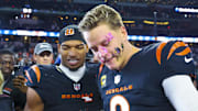 Dec 9, 2024; Arlington, Texas, USA;  Cincinnati Bengals wide receiver Ja'Marr Chase (1) smashes a donut on the face of Cincinnati Bengals quarterback Joe Burrow (9) after the game against the Dallas Cowboys at AT&T Stadium. Mandatory Credit: Kevin Jairaj-Imagn Images