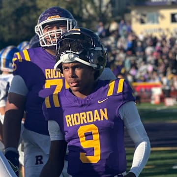 Riordan junior quarterback Mike Mitchell leads the handshake line after a stirring 27-21 home win over Serra in 2024; Riordan will face Serra again next week with the West Catholic Athletic League title on the line after beating Mitty 37-7 on Saturday. 