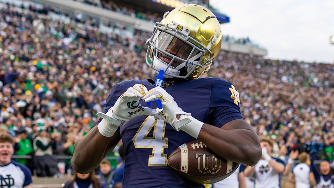 Notre Dame Fighting Irish running back Jeremiyah Love celebrates scoring against the Syracuse Orange.