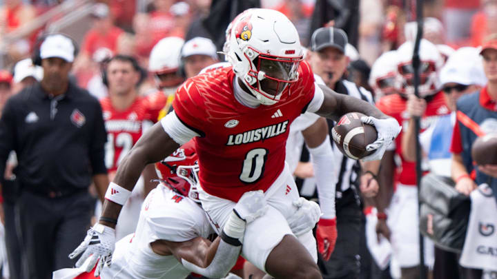 Louisville Cardinals wide receiver Chris Bell (0) runs down the field through Austin Peay Governors defensive back Cinque Williams (4) hold during their game on Saturday, Aug. 31, 2024 at L&N Federal Credit Union Stadium in Louisville, Ky.