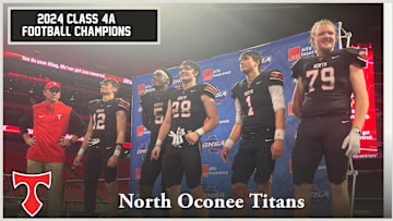 The North Oconee Titans await the Class 4A trophy presentation after defeating Marist Monday night in Mercedes-Benz Stadium. /GHSA