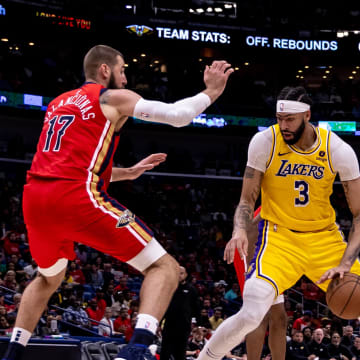 Apr 16, 2024; New Orleans, Louisiana, USA; Los Angeles Lakers forward Anthony Davis (3) dribbles against New Orleans Pelicans center Jonas Valanciunas (17) during the second half of a play-in game of the 2024 NBA playoffs at Smoothie King Center.