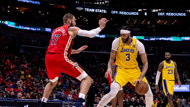 Apr 16, 2024; New Orleans, Louisiana, USA; Los Angeles Lakers forward Anthony Davis (3) dribbles against New Orleans Pelicans center Jonas Valanciunas (17) during the second half of a play-in game of the 2024 NBA playoffs at Smoothie King Center.