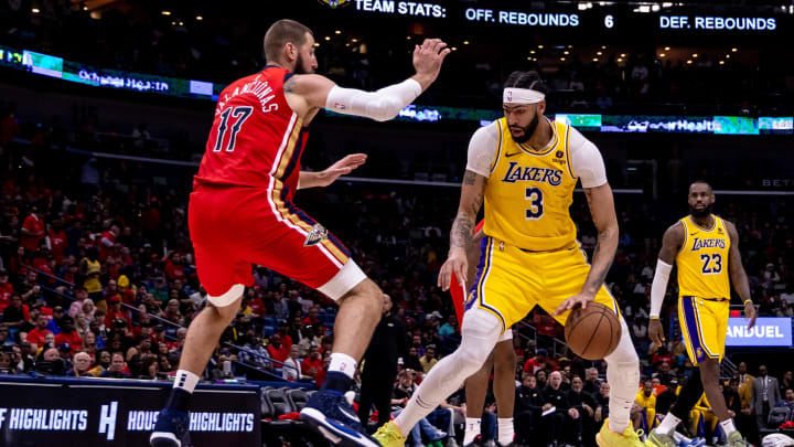 Apr 16, 2024; New Orleans, Louisiana, USA; Los Angeles Lakers forward Anthony Davis (3) dribbles against New Orleans Pelicans center Jonas Valanciunas (17) 