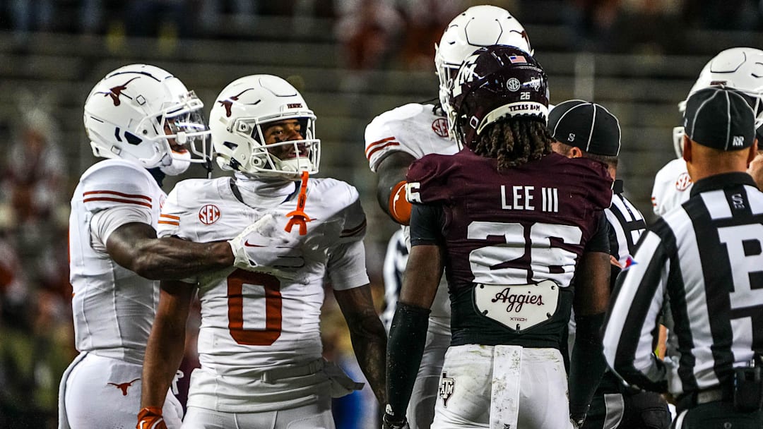 Texas Longhorns receiver DeAndre Moore Jr. (0) gets into a verbal argument with Texas A&M defensive back Will Lee III (26) during the Lone Star Showdown at Kyle Field on Saturday, Nov. 30, 2024 in College Station, Texas.