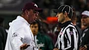 Nov 30, 2024; College Station, Texas, USA; Texas A&M head coach Mike Elko argues with an official about an overturned targeting call against the Texas Longhorns during the Lone Star Showdown at Kyle Field. Mandatory Credit: Sara Diggins/USA TODAY Network via Imagn Images