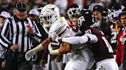Nov 30, 2024; College Station, Texas, USA; Texas Longhorns tight end Gunnar Helm (85) is tackled by Texas A&M defensive back Dezz Ricks (10) during the Lone Star Showdown at Kyle Field. Mandatory Credit: Sara Diggins/USA TODAY Network via Imagn Images