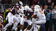 Nov 30, 2024; College Station, Texas, USA; Texas longhorns edge rusher Ethan Burke (91) stops Texas A&M running back Amari Daniels (5) on fourth and goal at the 1-yard line during the Lone Star Showdown at Kyle Field. Mandatory Credit: Sara Diggins/USA TODAY Network via Imagn Images